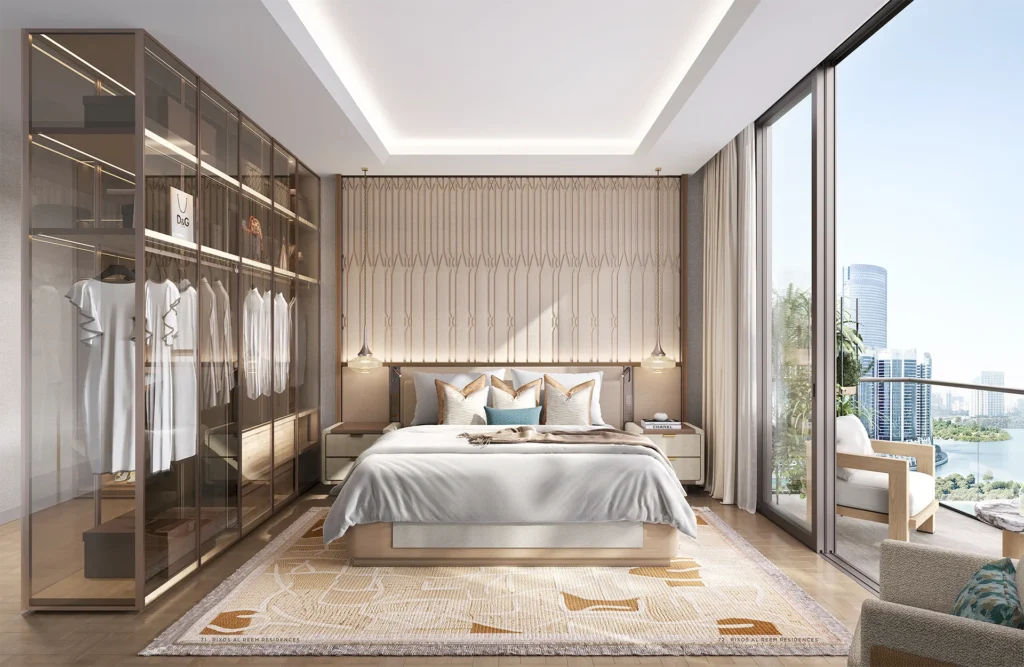 Luxury bedroom interior with balcony view at Rixos Al Reem Residences Abu Dhabi